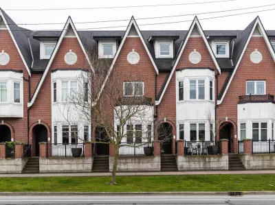 Row of brick three-story townhomes in Britih Columbia.