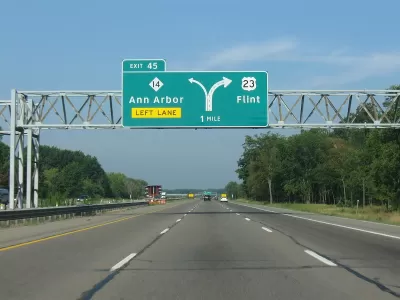 Green highway signs on Highway 23 for Ann Arbor and Flint, Michigan.