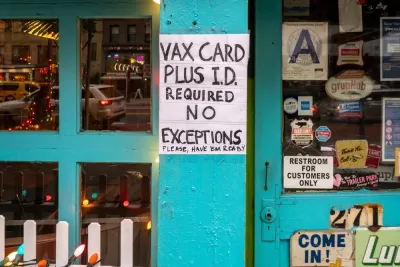 A sign outside a shop reads "VAX Card plus I.D. required for entry, no exceptions."