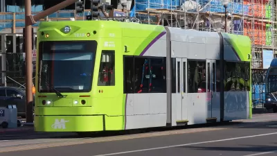 Green and gray Tempe streetcar on street in Tempe, Arizona