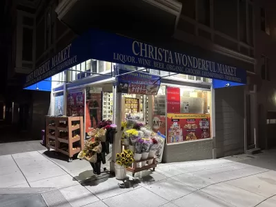A picture of a corner store at night.