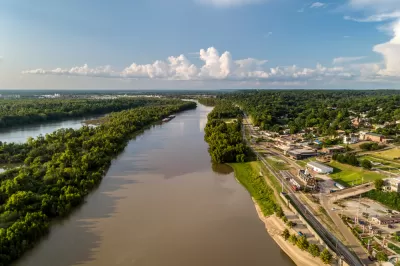 A diversion canal from the Yazoo River is shown from above. The river's banks are lined with industrial land uses near the city of Vicksburg, Mississippi.
