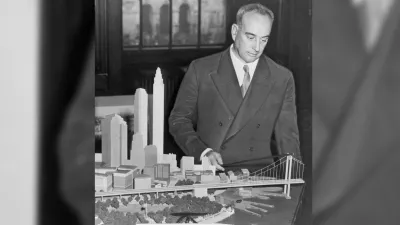 Robert Moses standing over model of city and bridge.