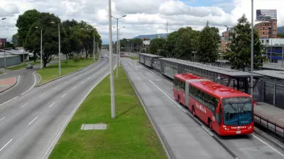 Red transmilenio bus stopped at station in Bogota