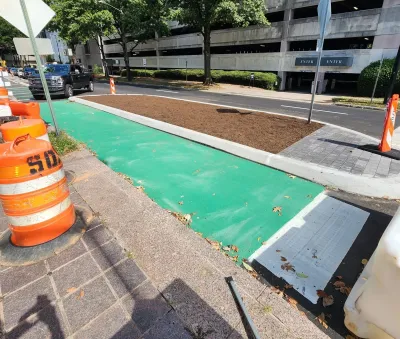 Green painted and curb protected bike lane under construction in Atlanta, Georgia.
