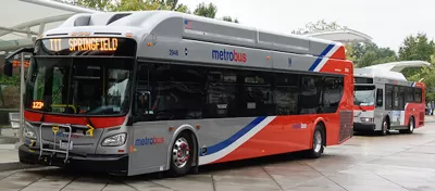 Silver and red WMATA public bus at station in Washington, D.C.