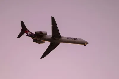 Hawaiian Airlines airplane flying in a pink sky