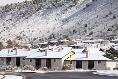 One-story houses dusted with snow in Durango, Colorado with snowy mountainside in background