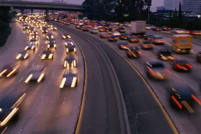 View of blurry speeding cars on freeway at sunset