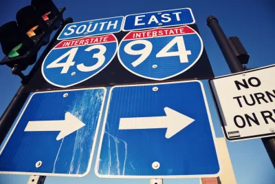 Closeup of blue I-94 and I-43 signs with arrows