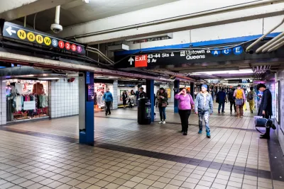 New York City subway station with people walking through.