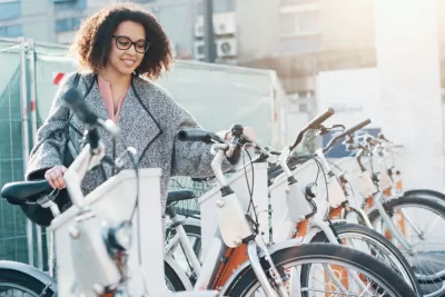 Woman accessing bike at bike share station