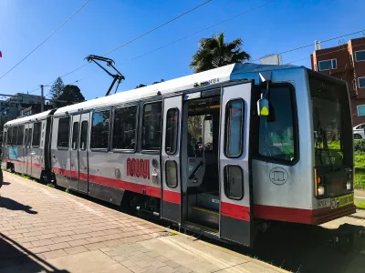 Red and white San Francisco Muni tram.