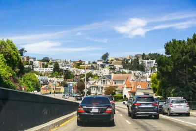 Cars driving into a residential neighborhood in San Fransisco.