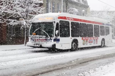 White SEPTA bus driving through snow in Philadelphia, Pennsylvania
