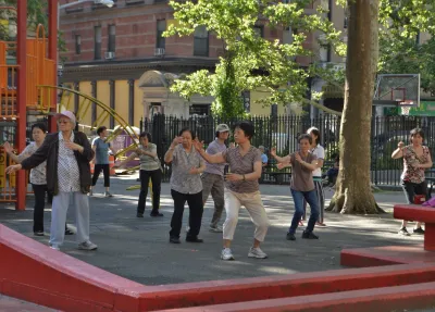Group of seniors doing tai chi in park in New York City.