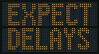 Yellow on black "Expect Delays" traffic sign