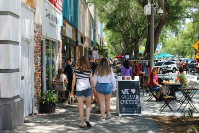 People walking down busy commercial street in St. Petersburg, Florida.