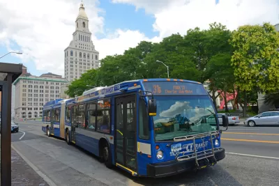 Blue CT Transit bus in Hartford, Connecticut with state capitol building in background