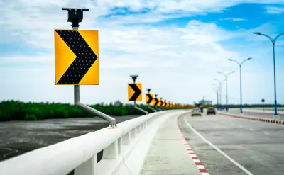 Close-up of curve ahead sign on highway