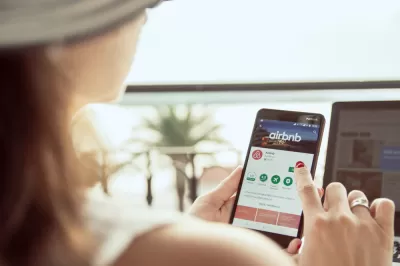 Woman searchinig Airbnb app on phone