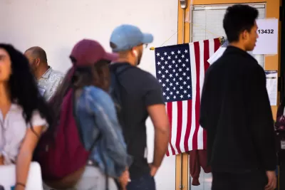 Group of people waiting in line at polling place