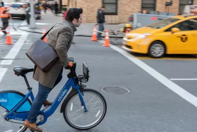 Man with leather messenger bag riding CitiBike bike on New York street