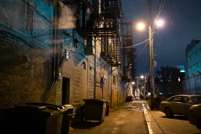A dark, empty urban alley at night.