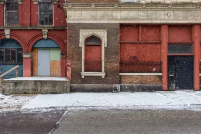 Boarded-up facade of vacant brick building in CIncinnati, Ohio