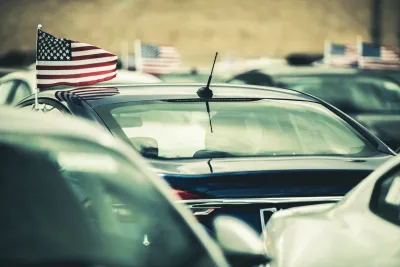 Close-up on cars with small American flags flying above driver side windows.