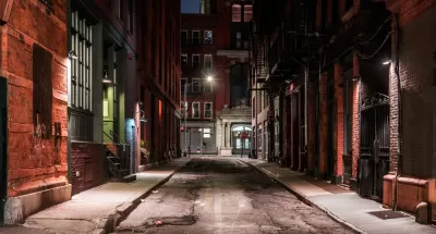 View down New York City alleyway at nighttime