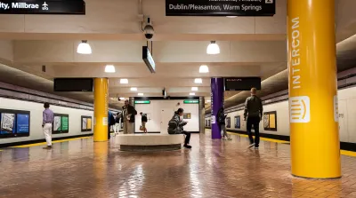 Underground transit station in San Francisco, California with few passengers waiting for trains.