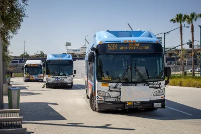 White Anaheim public transit bus on street.