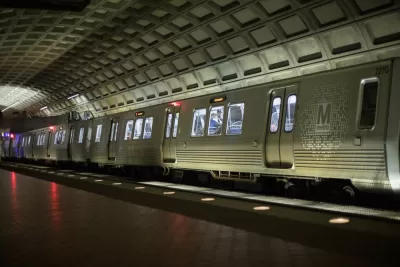 Silver DC Metro train in underground station with high arched ceiling