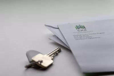 Close-up of house key on table and corner of envelope from Chicago Housing Authority