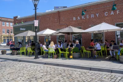 Outdoor dining with bright green chairs on a sidewalk in Baltimore, Maryland
