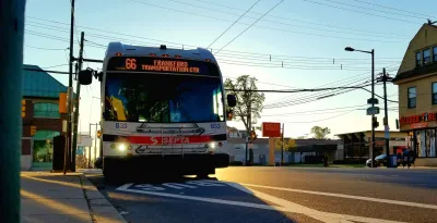 SEPTA bus pulling up to stop against dusk sky in Philadelphia, Pennsylvania.