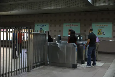 People entering silver fare gates in Los Angeles Metro station.