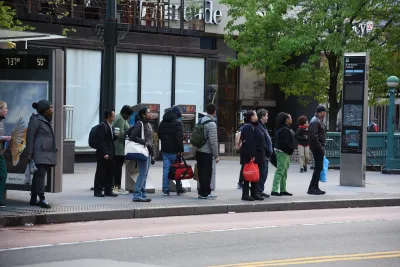 People waiting at bus stop in New York City.