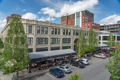 Downtown Asheville, North Carolina with parking lot in foreground next to red brick building.