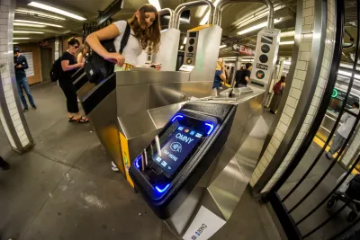 Close-up on OMNY card reader on turnstile at NYC subway station.