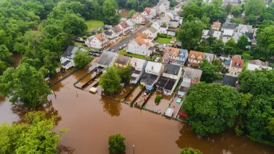 Brown floodwaters in residential neighborhood in New Jersey.
