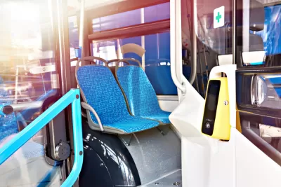 Cashless fare validator on bus with blue seat upholstery