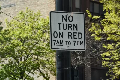 "No right turn on red 7am to 7pm" sign on black post