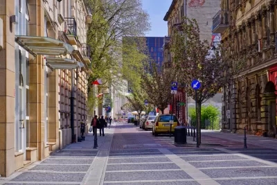 Woonerf street with no curbs and trees in Lodz, Poland