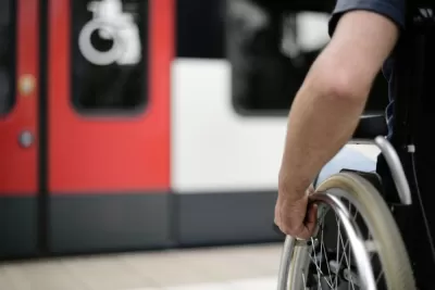 Close-up of wheelchair user on subway platform