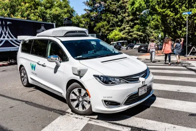 White Waymo robotaxi van.