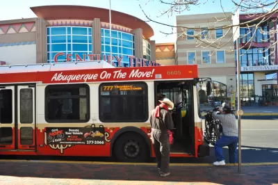 Red Albuquerque bus with man boarding
