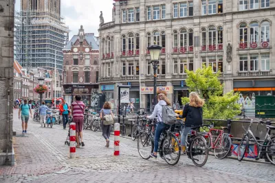 People on bikes on a cobblestone street in Utrecht, Netherlands.