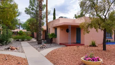 Red one-story Tucson home with gravel front yard